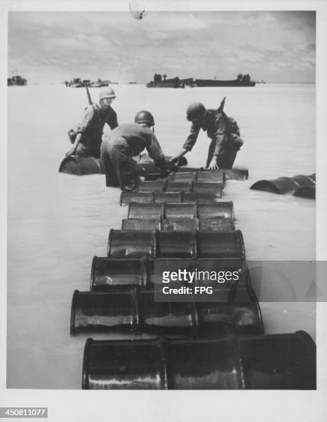 Soldiers rolling out supplies during the allied invasion of Iwo Jima during World War Two, Japan, 1945.