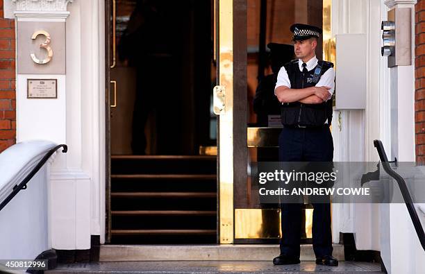 Policeman stands guard at the front door of the Ecuadorian Embassy in London on June 18, 2014 where Australian-born activist Julian Assange remains...