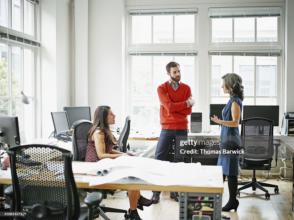 Group of colleagues in informal meeting in office