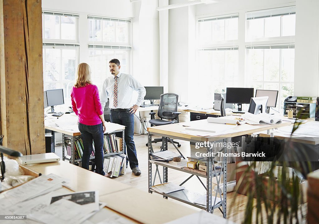 Businessman and businesswoman discussing project