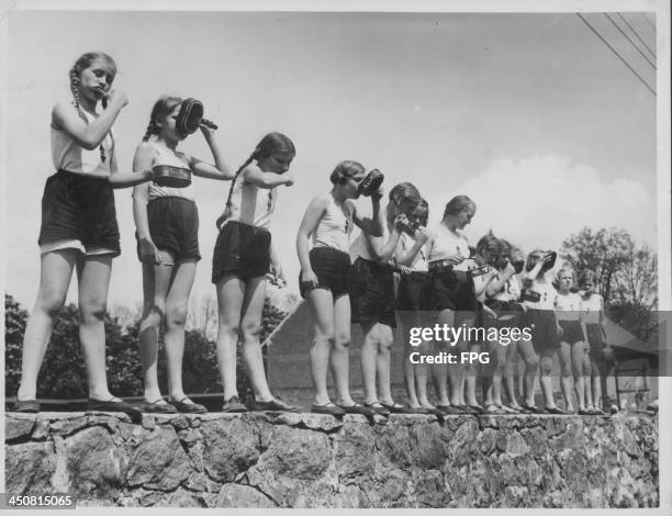 Young girls recruited as Hitler Youth members, being trained in the importance of cleanliness during World War Two, Germany, circa 1939-1945.
