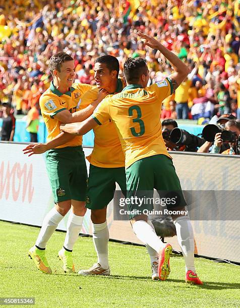 Tim Cahill of Australia celebrates with teammates Matt McKay and Jason Davidson after scoring his team's first goal during the 2014 FIFA World Cup...