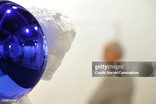 Visitor walks past to the artwork "Gazing Ball " by Jeff Koons in the gallery section of Art Basel on June 18, 2014 in Basel, Switzerland. Art Basel...