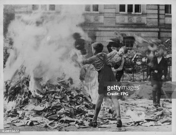 German school children burning Nazi books and paraphernalia following the end of World War Two, Cologne, Germany, circa 1945-1948.