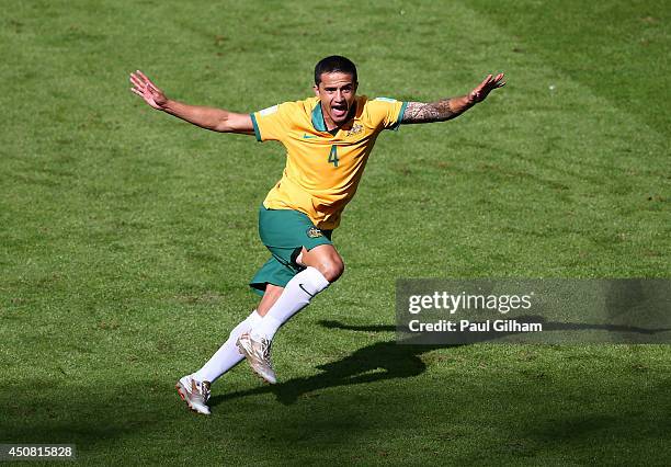 Tim Cahill of Australia celebrates after scoring his team's first goal during the 2014 FIFA World Cup Brazil Group B match between Australia and...