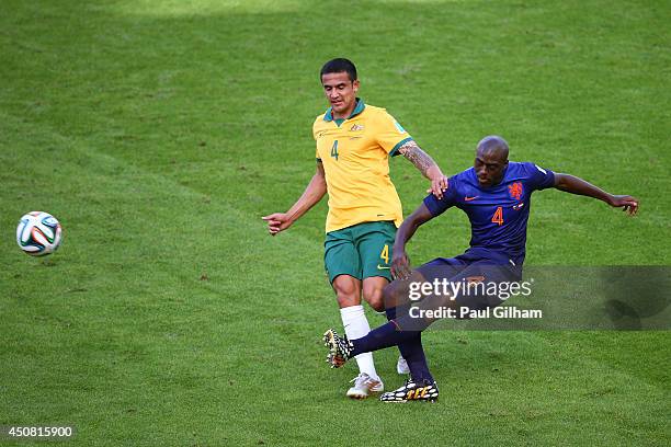 Tim Cahill of Australia challenges Bruno Martins Indi of the Netherlands during the 2014 FIFA World Cup Brazil Group B match between Australia and...