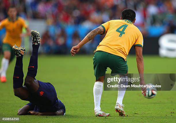 Bruno Martins Indi of the Netherlands falls to the field after a challenge by Australia during the 2014 FIFA World Cup Brazil Group B match between...