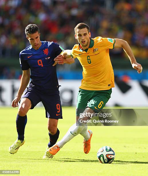 Robin van Persie of the Netherlands and Matthew Spiranovic of Australia compete for the ball during the 2014 FIFA World Cup Brazil Group B match...