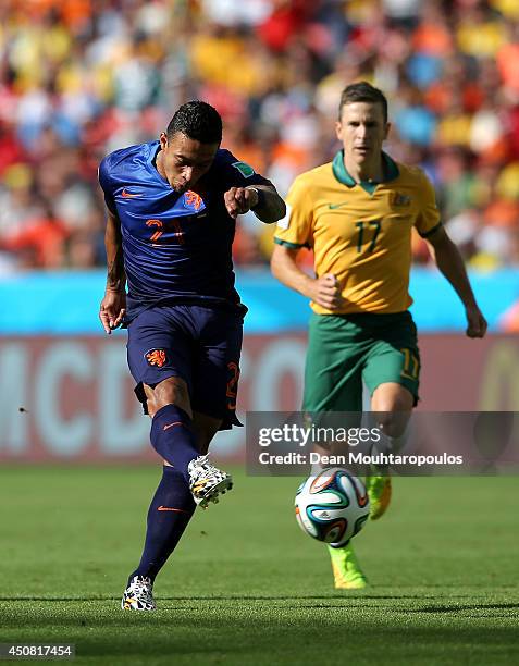 Memphis Depay of the Netherlands shoots and scores his team's third goal during the 2014 FIFA World Cup Brazil Group B match between Australia and...