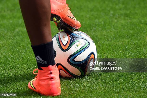 Colombian player puts his boot on a Brazuca official ball during a training session of the Colombian team in Brasilia on June 18 on the eve of their...