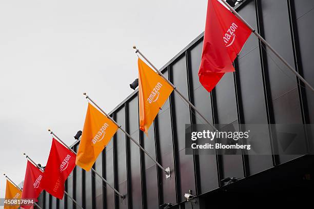 Amazon.com Inc. Flags fly before the start of an event at Fremont Studios in Seattle, Washington, U.S., on Wednesday, June 18, 2014. Amazon.com Inc....