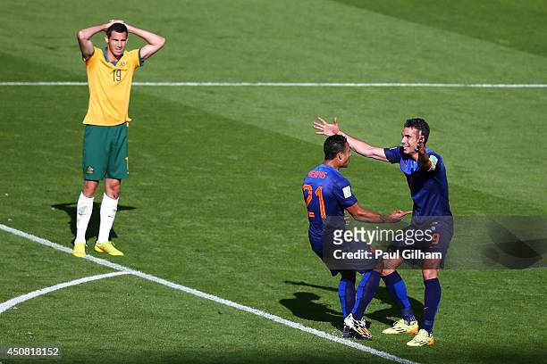 Memphis Depay of the Netherlands celebrates scoring his team's third goal with Robin van Persie as Ryan McGowan of Australia looks on during the 2014...