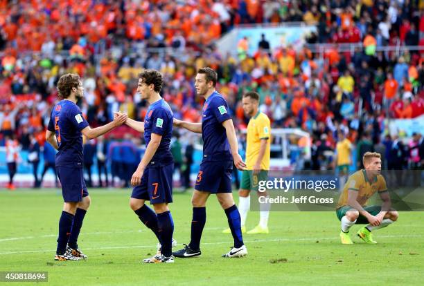 Daley Blind, Daryl Janmaat and Stefan de Vrij of the Netherlands celebrate after defeating Australia 3-2 during the 2014 FIFA World Cup Brazil Group...