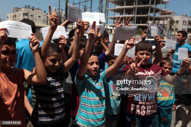 Palestinian children hold up signs reading "Letter from Palestinian children to International Committee of the Red Cross" during a demonstration in...