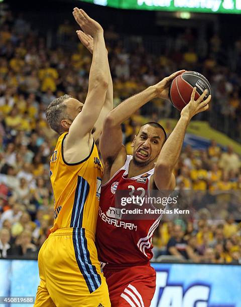 Yassin Idbihi of Muenchen is attackt by Sven Schultze of Berlin during the Beko BBL playoff final game 4 between Alba Berlin and Bayern Muenchen at...