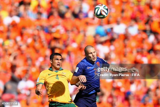 Tim Cahill of Australia goes up for the ball with Ron Vlaar of the Netherlands during the 2014 FIFA World Cup Brazil Group B match between Australia...