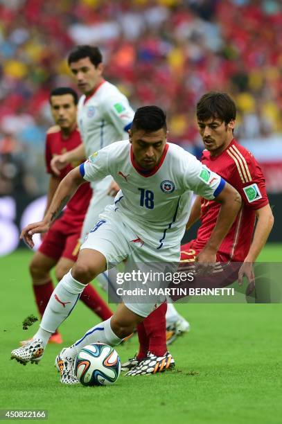 Chile's defender Gonzalo Jara and Spain's midfielder David Silva vie for the ball during a Group B football match between Spain and Chile in the...