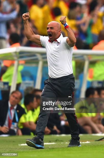 Head coach Jorge Sampaoli of Chile reacts after his team's first goal during the 2014 FIFA World Cup Brazil Group B match between Spain and Chile at...
