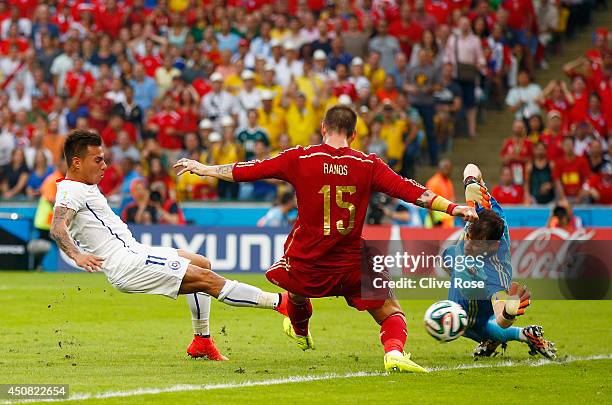 Eduardo Vargas of Chile shoots and scores his team's first goal past Sergio Ramos and goalkeeper Iker Casillas of Spain during the 2014 FIFA World...