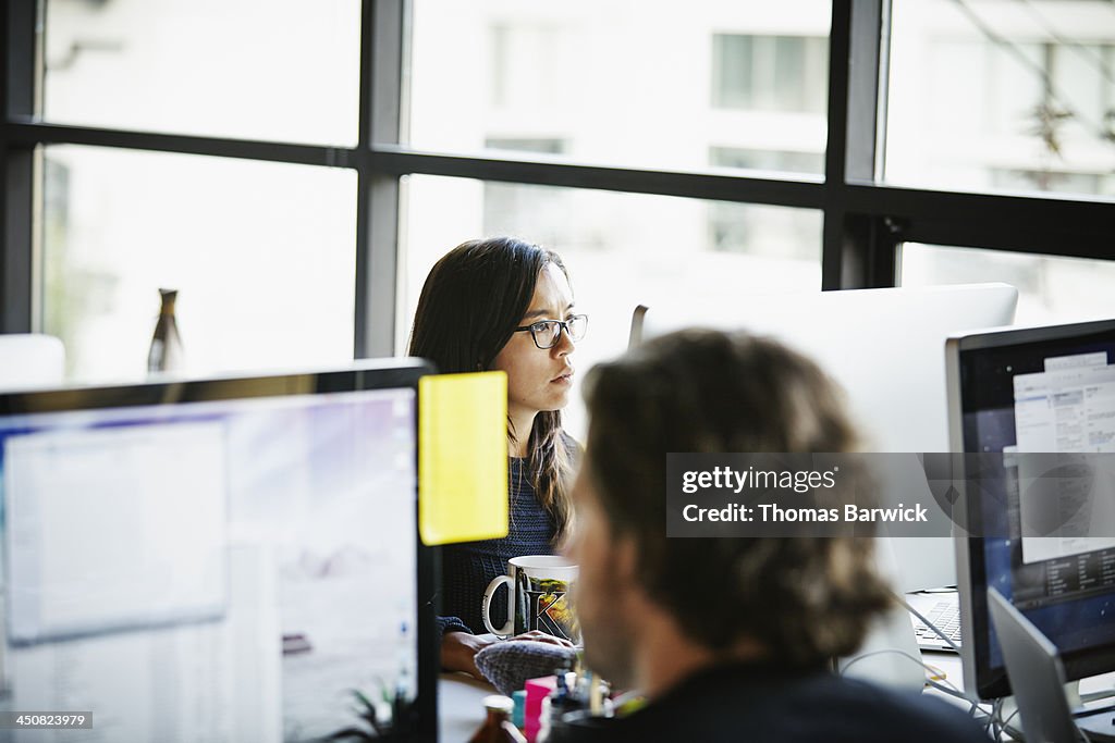 Businesswoman on computer at office workstation