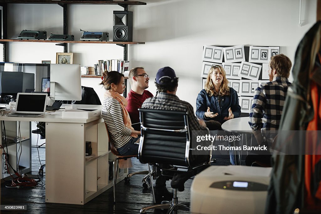 Businesswoman leading meeting in startup office