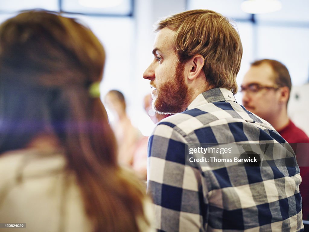 Businessman participating in meeting in office