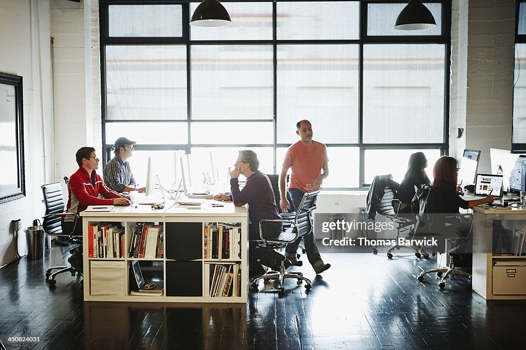 Coworkers at workstations in high tech office