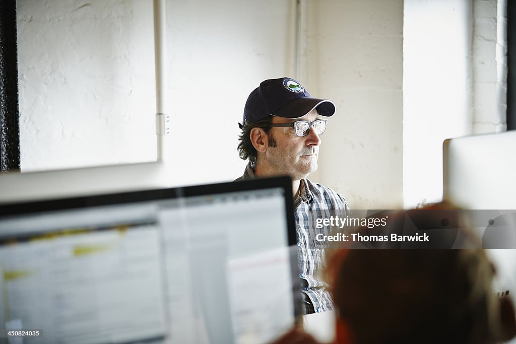 Businessman sitting at desk working on computer