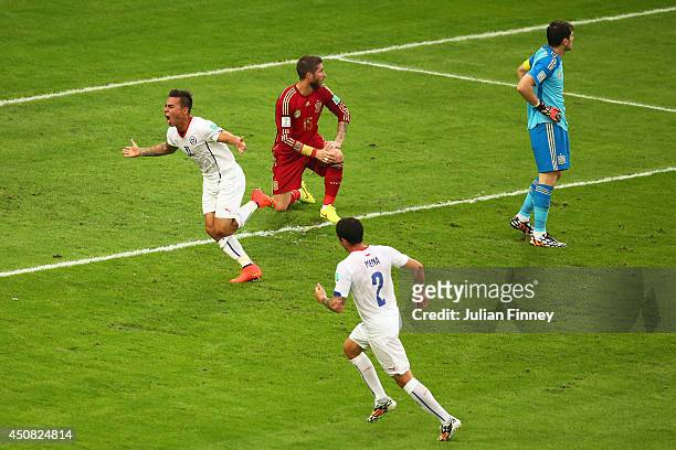 Eduardo Vargas of Chile celebrates after scoring his team's first goal past Iker Casillas of Spain during the 2014 FIFA World Cup Brazil Group B...