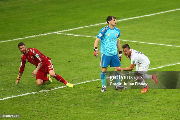 Eduardo Vargas of Chile celebrates after scoring his team's first goal past Sergio Ramos and goalkeeper Iker Casillas of Spain during the 2014 FIFA...