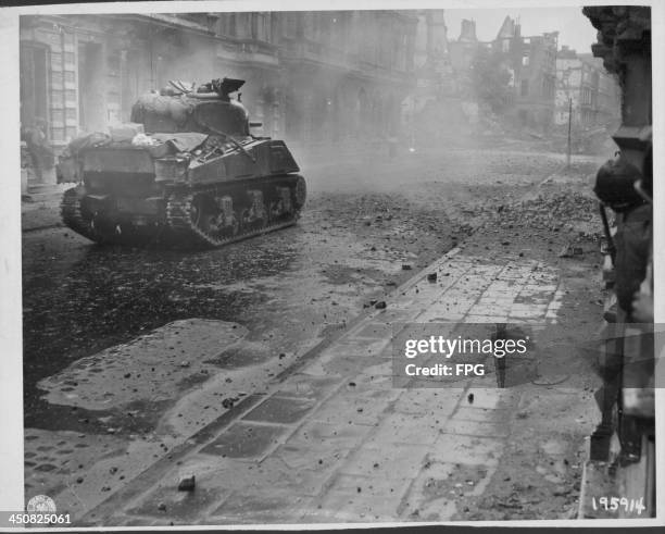 Tanks and infantry advance on German forces in the town of Aachen during World War Two, Germany, October 15th 1944.