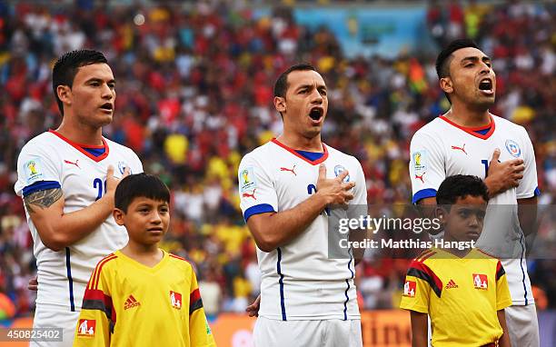 Charles Aranguiz, Marcelo Diaz and Gonzalo Jara of Chile sing the National Anthem during the 2014 FIFA World Cup Brazil Group B match between Spain...