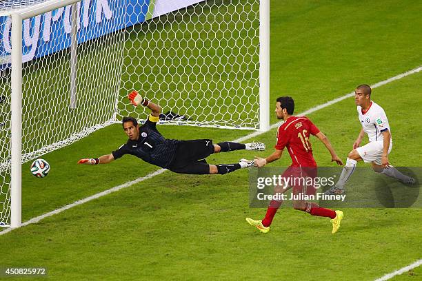 Sergio Busquets of Spain shoots and misses wide of the net against goalkeeper Claudio Bravo of Chile during the 2014 FIFA World Cup Brazil Group B...