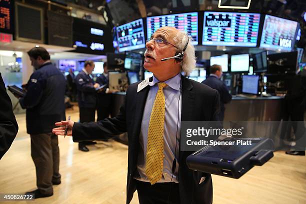 Trader works on the floor of the New York Stock Exchange on June 18, 2014 in New York City. The Dow was up 98 points at the end of the trading day...
