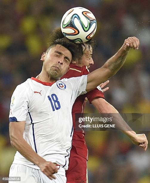Chile's defender Gonzalo Jara and Spain's midfielder David Silva vie during a Group B football match between Spain and Chile in the Maracana Stadium...