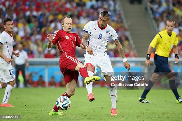 Andres Iniesta of Spain and Arturo Vidal of Chile in action during the 2014 FIFA World Cup Brazil Group B match between Spain and Chile at Estadio...