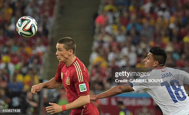 Spain's forward Fernando Torres and Chile's defender Gonzalo Jara vie for the ball during a Group B football match between Spain and Chile in the...