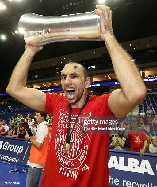 Yassin Idbihi of Muenchen pose with the cup after winning the Beko BBL playoff final game 4 between Alba Berlin and Bayern Muenchen at O2 World on...