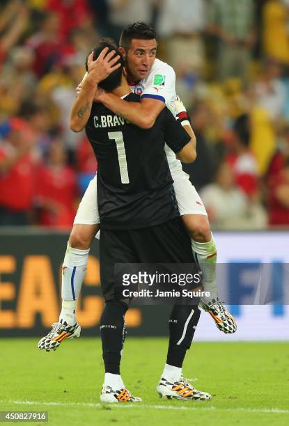 Claudio Bravo of Chile celebrates with Mauricio Isla after defeating Spain 2-0 during the 2014 FIFA World Cup Brazil Group B match between Spain and...