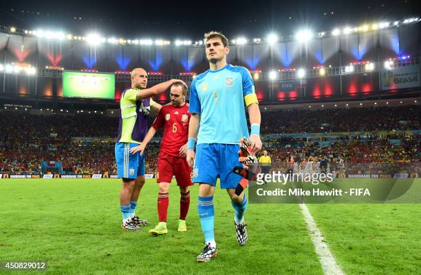 Pepe Reina of Spain consoles Andres Iniesta and Iker Casillas as they walk off the pitch during the 2014 FIFA World Cup Brazil Group B match between...