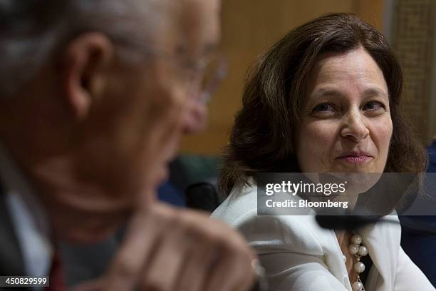 Sarah Bloom Raskin, governor of the U.S. Federal Reserve and nominee to be deputy U.S. Treasury secretary, right, looks on as former Senator Paul...