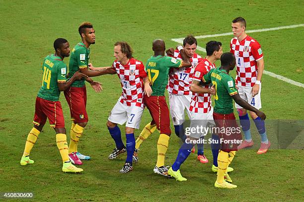 Charles Itandje of Cameroon fights for position with Mario Mandzukic of Croatia before a corner kick during the 2014 FIFA World Cup Brazil Group A...