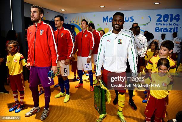 Stipe Pletikosa of Croatia and Nicolas N'Koulou of Cameroon lead their teams in the tunnel prior to the 2014 FIFA World Cup Brazil Group A match...