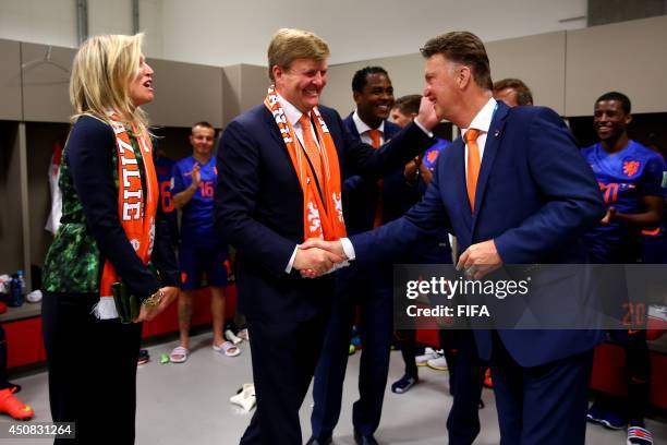 In this handout image supplied by the FA, King Willem-Alexander of the Netherlands and Queen Maxima of the Netherlands celebrate with coach Louis van...