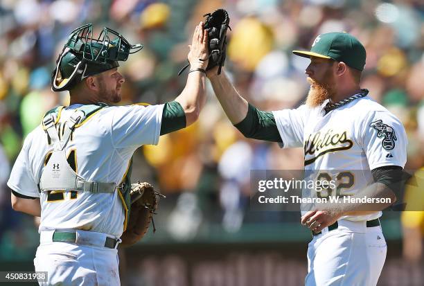 Sean Doolittle and Stephen Vogt of the Oakland Athletics celebrate defeating the Texas Rangers 4-2 at O.co Coliseum on June 18, 2014 in Oakland,...