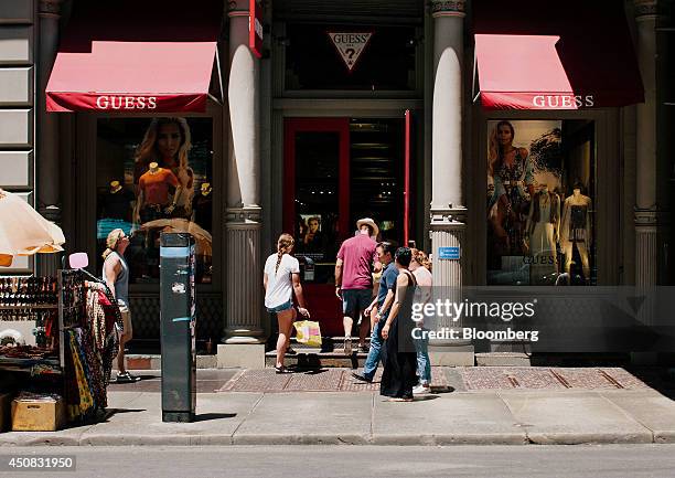 Customers enter a Guess? Inc. Store in the SoHo neighborhood of New York, U.S., on Wednesday, June 18, 2014. The Bloomberg Consumer Comfort Index, a...