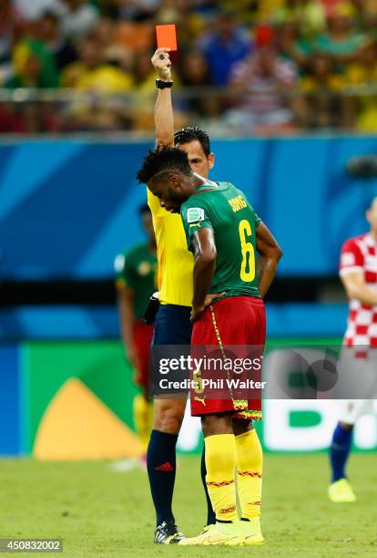 Alex Song of Cameroon is shown a red card by referee Pedro Proenca during the 2014 FIFA World Cup Brazil Group A match between Cameroon and Croatia...