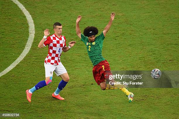 Ivan Perisic of Croatia competes for the ball wtih Benoit Assou-Ekotto of Cameroon during the 2014 FIFA World Cup Brazil Group A match between...