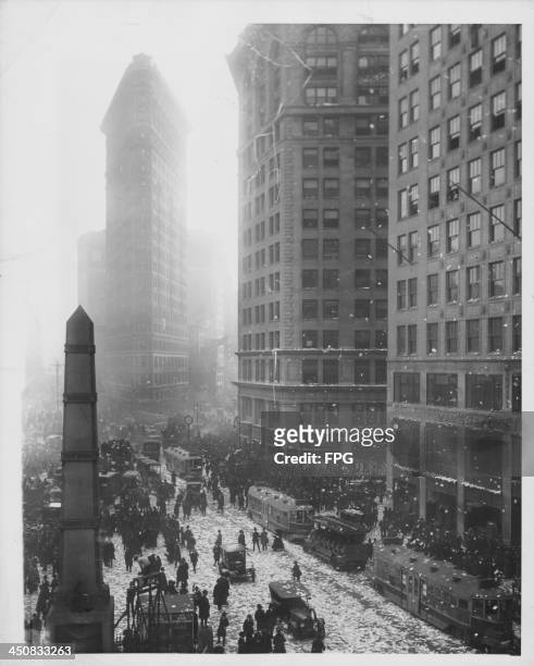 Confetti covers the streets near the Flatiron Building during celebrations for the signing of the Armistice ending World War I, New York City, USA,...