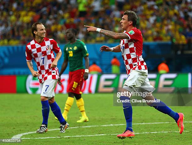 Mario Mandzukic of Croatia celebrates scoring his team's third goal with Ivan Rakitic during the 2014 FIFA World Cup Brazil Group A match between...